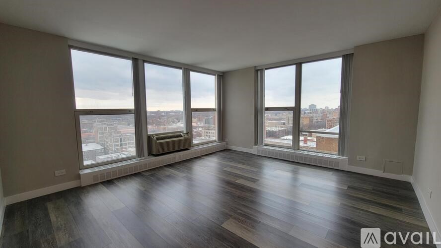 A spacious room with large windows overlooking a cityscape.