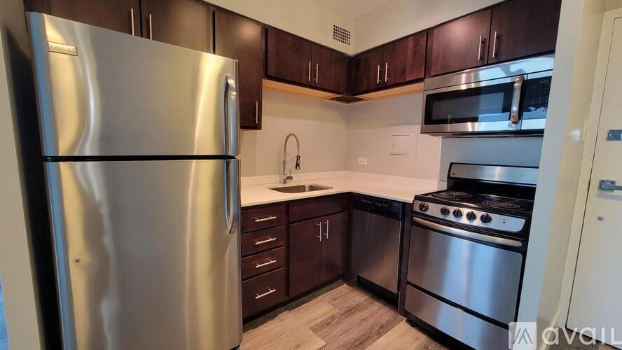 A kitchen with a stainless steel refrigerator, oven, and microwave.
