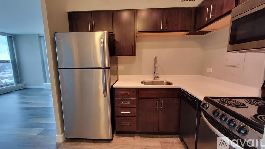 A kitchen with a stainless steel refrigerator and stove.