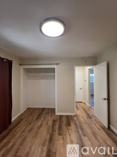 A room with wooden floors and a ceiling light.