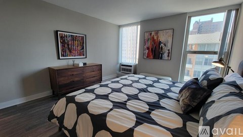 A bedroom with a bed, dresser, and two pictures on the wall.