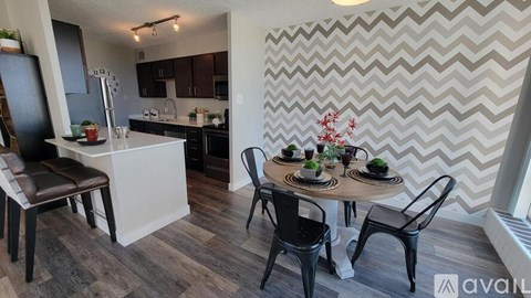 A kitchen with a dining table set for four.