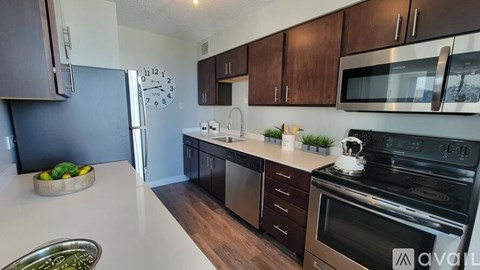 A kitchen with a white countertop and stainless steel appliances.