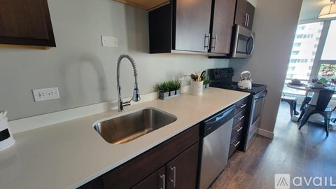 A kitchen with a sink and a microwave.