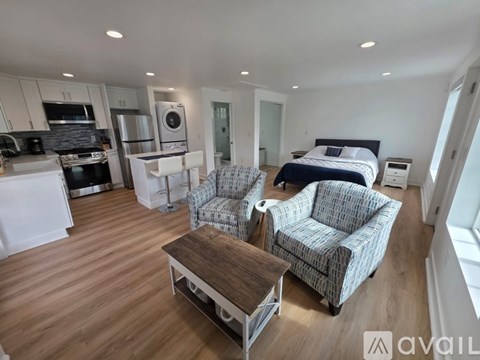A living room with a couch, chair, and coffee table.