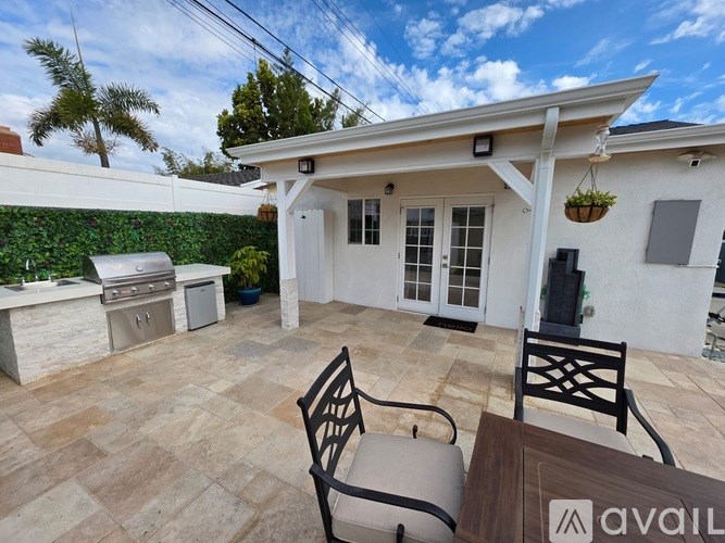 A patio area with a table and chairs is available for rent.