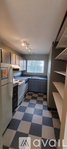 A kitchen with black and white checkered floor.
