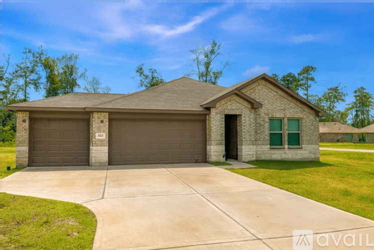 A house with a brown garage door and a brown roof.