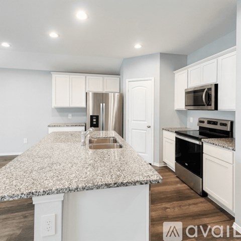 A kitchen with granite countertops and stainless steel appliances.