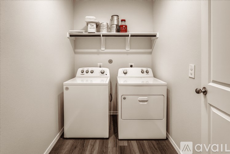 A bathroom with two sinks and a shelf above them.