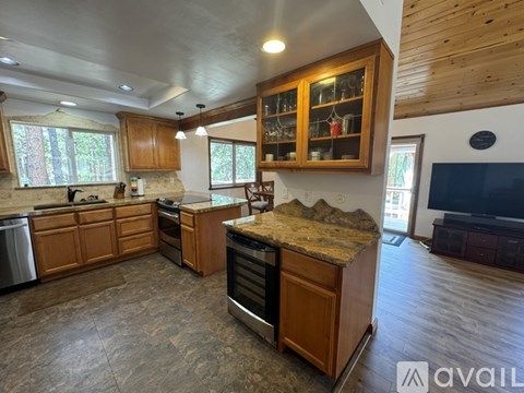A kitchen with wooden cabinets and a granite countertop.