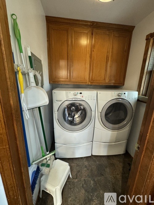 A small laundry room with a washer and dryer.