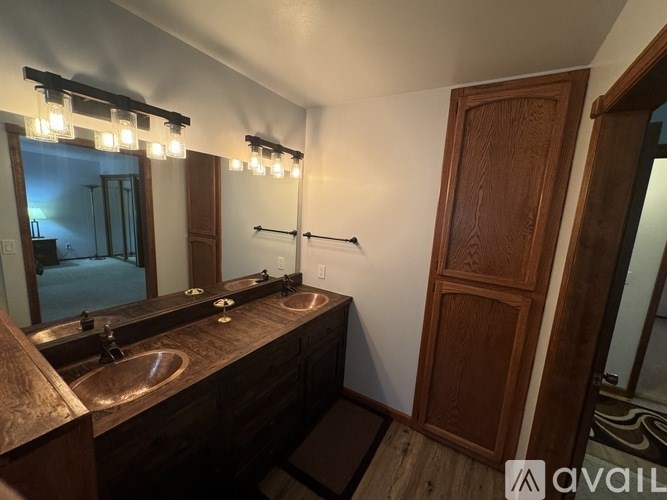 A bathroom with two sinks and a large mirror.
