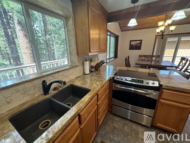 A kitchen with wooden cabinets and granite countertops.