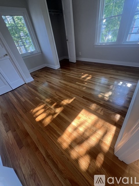 A room with wooden floors and white walls.