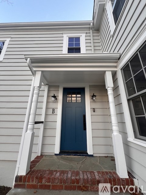 A house with a blue door and white columns.