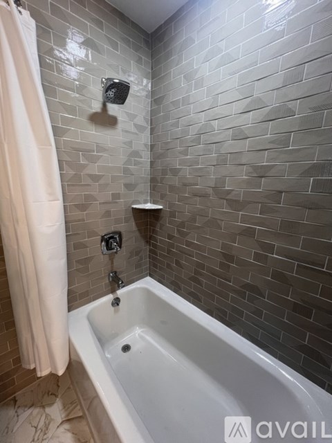 A bathroom with a white tub and a shower curtain.
