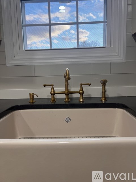 A bathroom sink with a window above it.