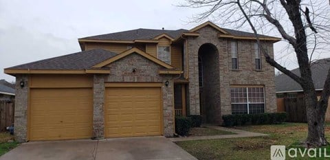 A house with a brown garage door is for sale.