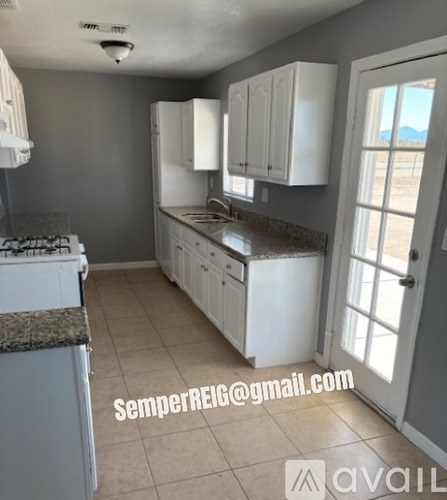 A kitchen with white cabinets and a counter top.