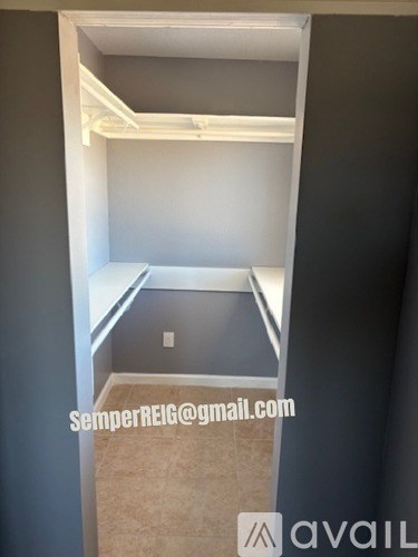 A room with a bed and a desk in it.