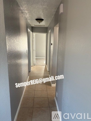 A long hallway with a door at the end.