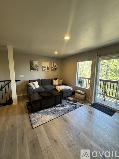 A living room with a grey couch and a coffee table.