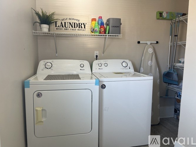 Two front loading washing machines in a laundry room.