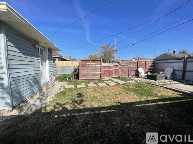A backyard with a fence and a house.