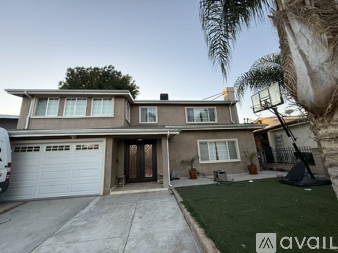 A house with a garage and a driveway is for sale.