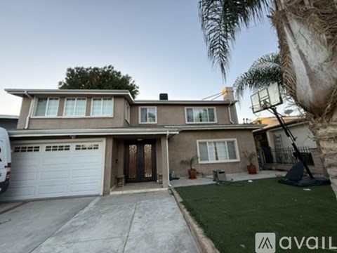 A house with a garage and a driveway is for sale.