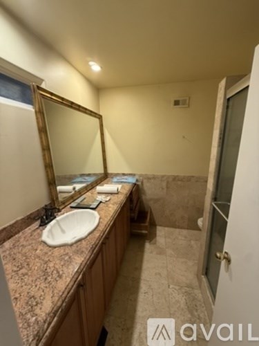 A bathroom with a sink and mirror.