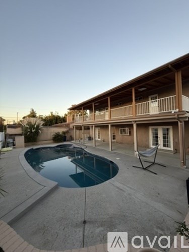 A large house with a pool in the backyard.