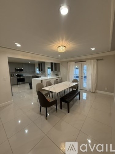 A modern dining room with a large table and chairs.
