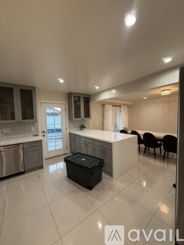 A kitchen with a dishwasher and a fridge.