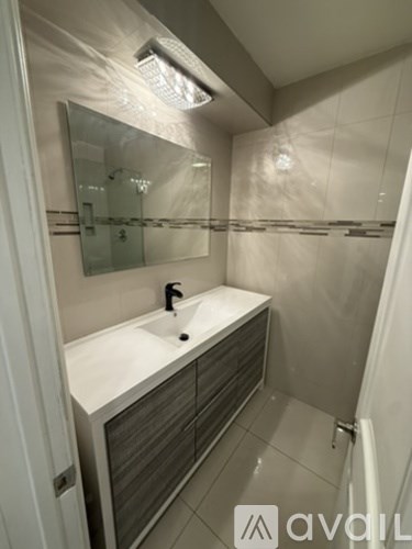 A bathroom with a sink and mirror.