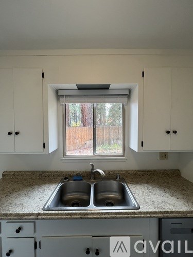 A kitchen with a sink and cabinets.