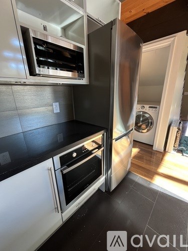 A kitchen with a stainless steel refrigerator and oven.