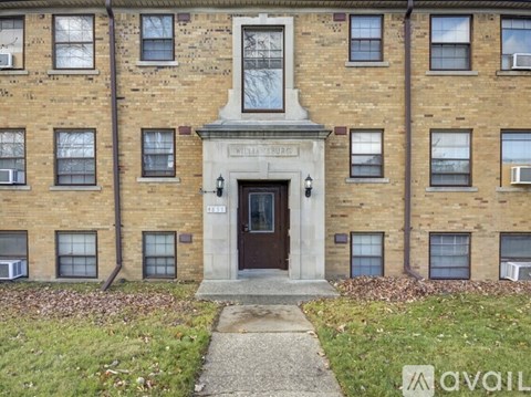 The front of a brick building with the words "Wellington Church" written on it.