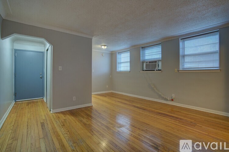 A room with wooden floors and a blue door.