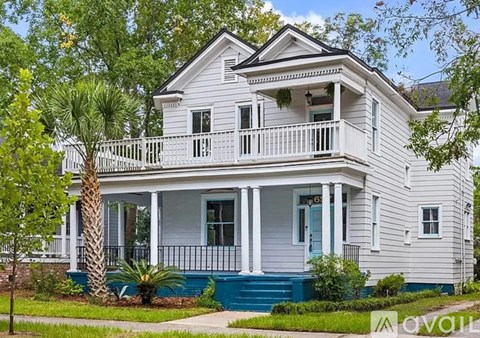 A white house with a blue front porch.