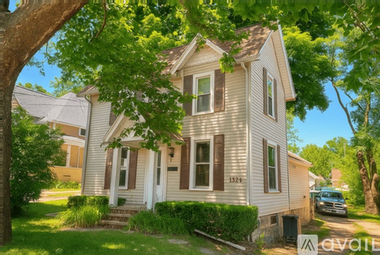 A house with a tree in front of it.