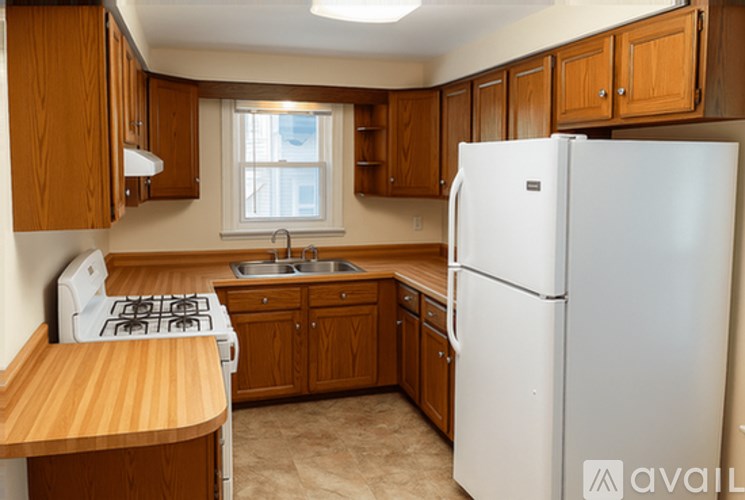 A kitchen with wooden cabinets and a white refrigerator.