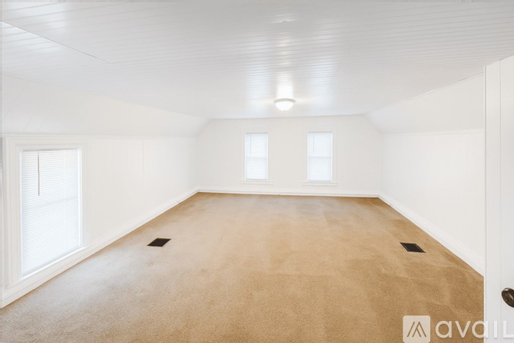 A room with white walls and a carpeted floor.