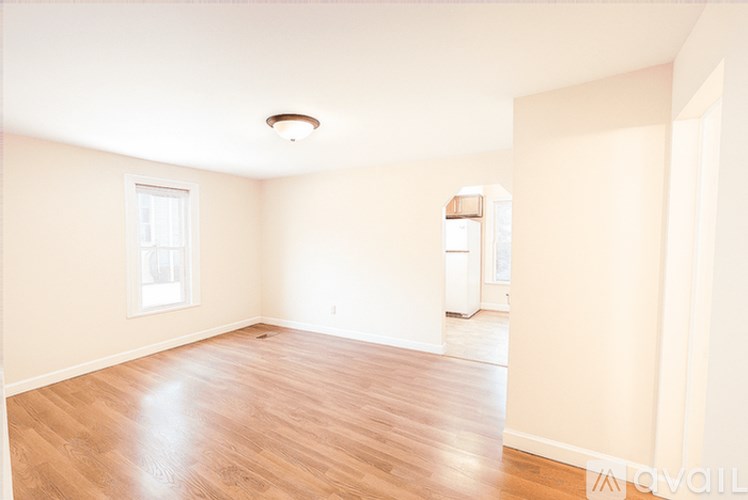 A room with wooden flooring and a window.