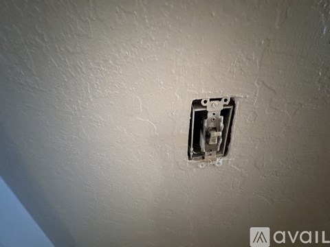A wall socket with a cable plugged in.