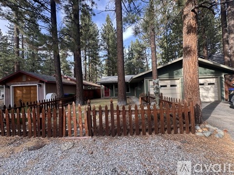 A house with a brown fence in front of it.