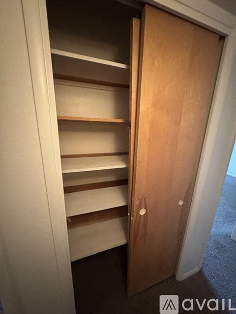 A wooden door with a handle and a small window on the right side.