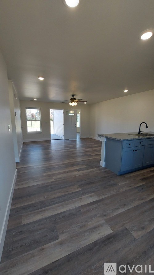 A kitchen with a blue cabinet and a wooden floor.
