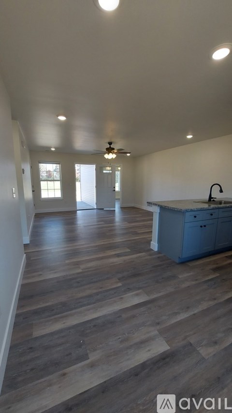 A kitchen with a blue cabinet and a wooden floor.